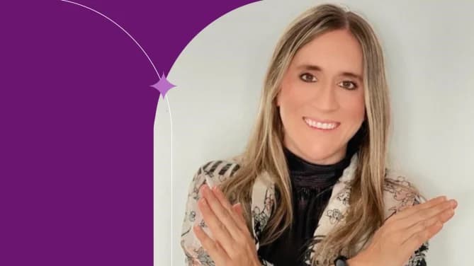 Picture of Maria Ximena Tribin wearing a black shirt with a floral blouse and smiling.