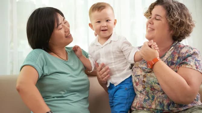 two people with a baby